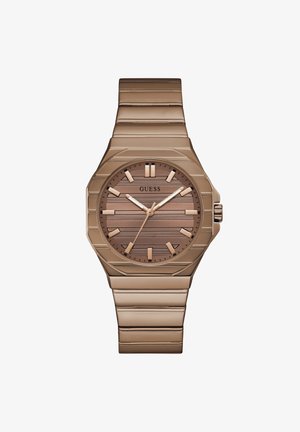 Rose gold metal wristwatch with linked band, textured dial, bold hour markers, and three hands showing 10:09:36, brand name Guess.
