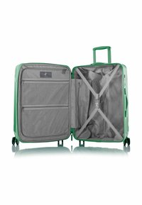 Groene harde koffer geopend, met een grijze binnenkant, netvakjes, verstelbare riemen en een uitschuifbare handgreep.