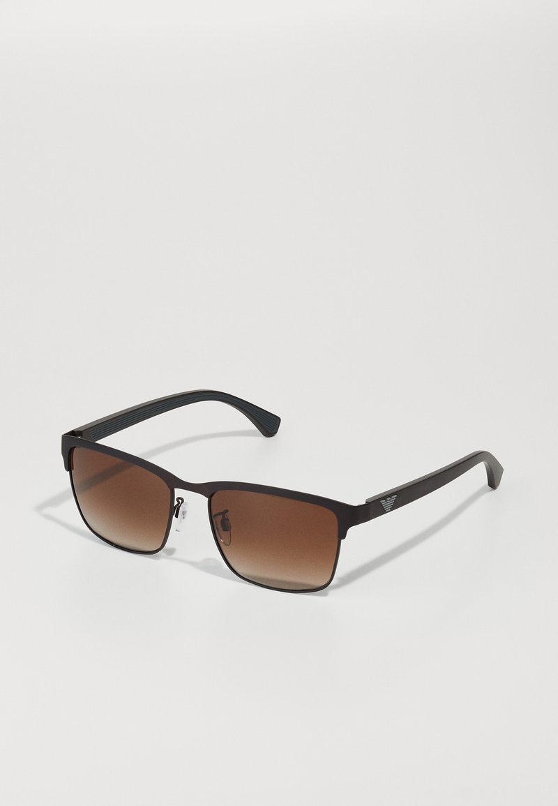 Brown gradient sunglasses with a sleek black frame, square lenses, and textured black temple arms featuring a small emblem.