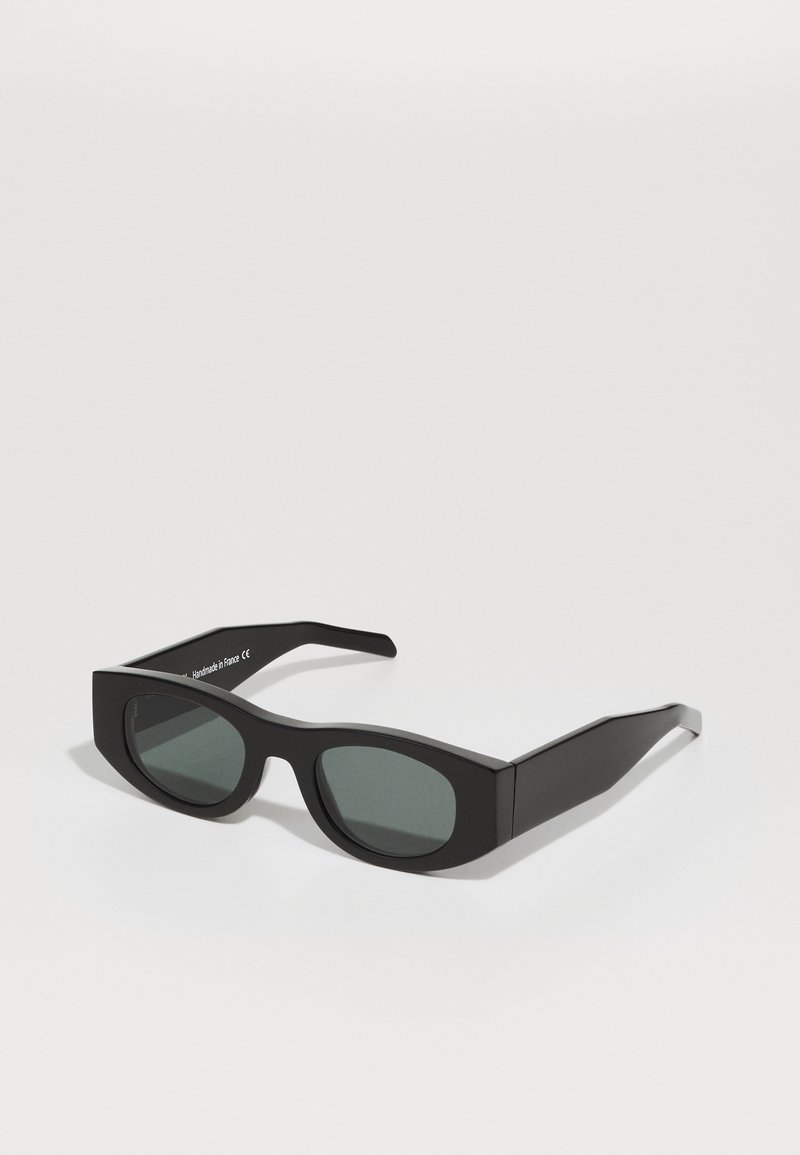 Black rectangular sunglasses with dark lenses, thick matte plastic frame, flat edges, and slightly tapered arms. No visible logos or accents.