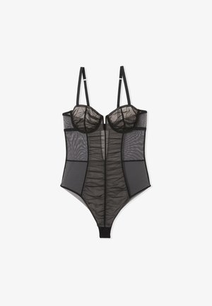 Black mesh bodysuit with sheer cups, textured ruffles, adjustable straps, and a high-cut leg design. Semi-transparent sections create a layered effect.