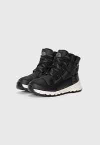 Black padded mid-top boots with textured fabric, contrasting white rubber sole, and black laces. Includes logo on tongue and side accent.