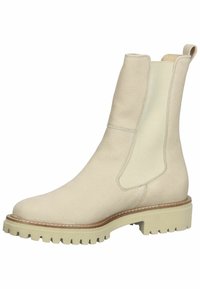 Botte Chelsea en cuir beige avec panneau latéral élastique, languette de tirage au talon, couture marron clair et semelle épaisse à crampons.