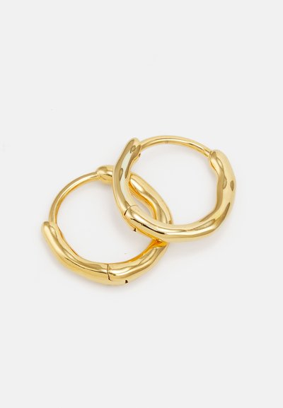 Gold hoop earrings featuring a smooth, rounded design with a slightly textured surface and a secure clasp mechanism.