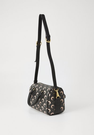 Black and pink patterned handbag with a smooth texture, oval designs, gold hardware accents, and an adjustable strap.