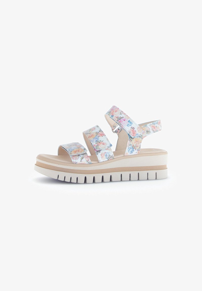 Floral-patterned slide sandals featuring three adjustable straps, a cushioned footbed, and a thick white platform sole with textured grooves.