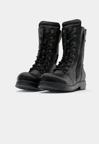 Black leather combat boots featuring a rounded toe, lace-up front, side zipper, and textured rubber outsole.