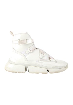 High-top white sneaker with chunky sole, featuring multiple adjustable fabric straps and a pull tab at the heel.