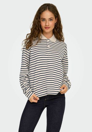 Gestreepte langarm polo shirt in crème en marineblauw. Heeft een klassieke kraag en een drie-knops sluiting. Zachte textuur met een ontspannen pasvorm.