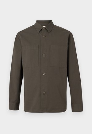 Dark olive green long-sleeve button-up shirt with a pointed collar and two chest pockets against a light gray background.