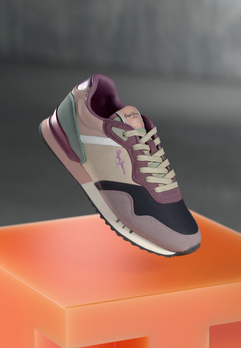 Sneaker with a mix of mauve, pink, and navy blue hues; fabric and leather materials; layered design; prominent logo, and textured accents.