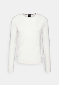 White long-sleeve sweater with a round neckline, made of smooth fabric. Features a tag on the bottom left, minimalistic design without patterns.