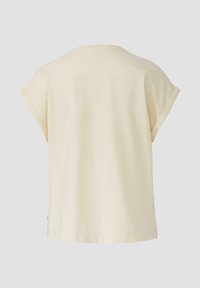 Korte mouwen, crèmekleurig T-shirt van katoen. Ronde hals, losse pasvorm, met opgerolde mouwen en een gladde textuur.
