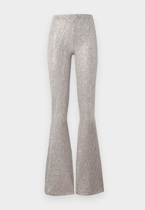 Silver sequined flared pants featuring a textured surface with vertical lines. Designed with a fitted waist and wider leg opening at the hem.