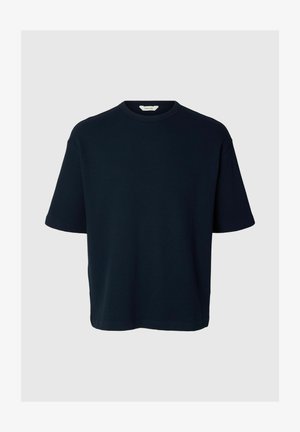 Tumesinine lühikeste varrukatega puuvillane t-särk ümmarguse kaelusega, soonilise tekstuuri ja lõdva lõikega.