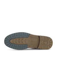 Semelle de chaussure en caoutchouc marron avec un design texturé, présentant un profil à motifs et des accents bleus contrastants. Surface lisse avec des rainures définies.