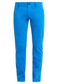 Jasnoniebieskie bawełniane spodnie o prostym kroju nogawek, z przodem zapinanym na guziki, szlufkami na pasek i kieszeniami bocznymi. Gładka faktura.