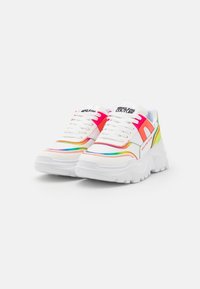 White sneakers with colorful accents in pink, orange, and green. Features a thick sole, mesh and synthetic upper, and contrasting stitching.