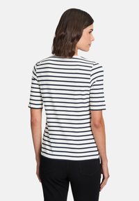 Navy and white striped short-sleeve shirt with a crew neckline, featuring a smooth texture and a straight hem. Seen from the back.