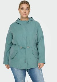 Mėlynas gobtuvas su džinsiniu pamušalu, pagamintas iš minkštos medžiagos, su raišteliu juosmeniui, priekinėmis kišenėmis ir laisvu siluetu. Subtili tekstūra su lygia apdaila.