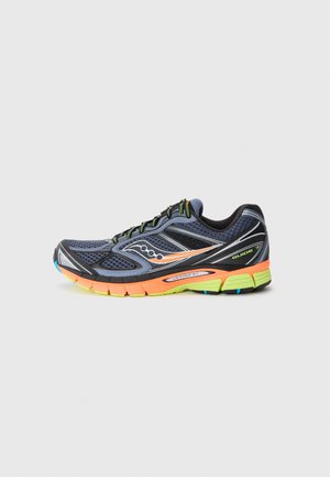 Sport shoe in dark blue mesh with black accents. Bright orange and yellow sole. Features a cushioned design and reflective stripes.