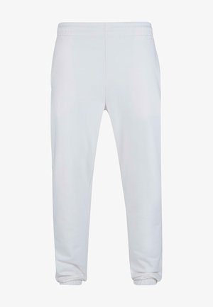 Pantaloni della tuta bianchi con cintura elastica, tasche laterali, gambe affusolate e polsini a costine per una vestibilità aderente. Materiale in morbido misto cotone.