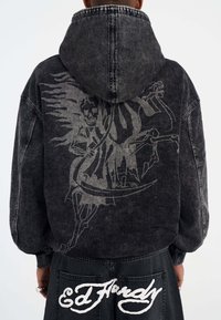 Black denim hoodie featuring a large gray graphic of a grim reaper design on the back, with a contrasting white logo on the lower hem.