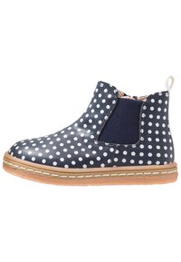 Bottines bleu marine avec des pois blancs, panneau latéral élastique, semelle piquée beige et languette au talon.