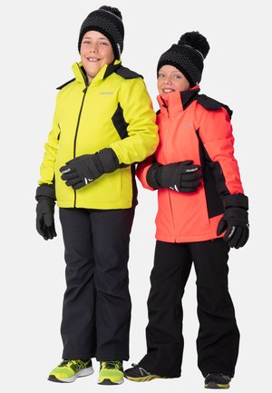 Two children wearing bright jackets; one in neon yellow with black accents, the other in coral. Both in black pants and gloves.