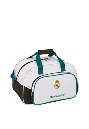 Biało-czarna torba sportowa Real Madryt z turkusowymi uchwytami, przednią kieszenią i logo drużyny nad tekstem "Real Madrid".