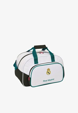 Biało-czarna torba sportowa Real Madryt z turkusowymi uchwytami, przednią kieszenią i logo drużyny nad tekstem "Real Madrid".