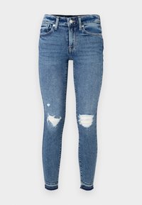 Közép kék farmer skinny farmernadrág, két elhasználódott térdrepedéssel, öt zsebes dizájnnal és klasszikus, közepes derékkal.
