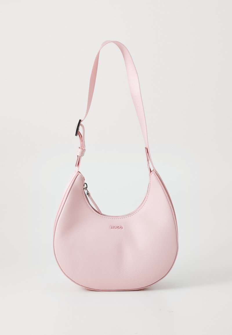Pink leather handbag with a curved shape, featuring a single adjustable strap and a debossed logo on the front. Smooth texture throughout.