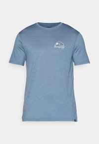 Light blue short-sleeve t-shirt made of soft, textured fabric. Features a white logo on the left chest area. Classic crew neck design.