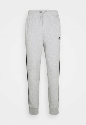 Light gray sweatpants with black side stripes, elastic waistband with drawstring, cuffed ankles, and small black Adidas logo on right thigh.