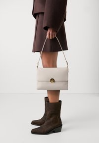 Coccinelle BINXIE - Handbag - white