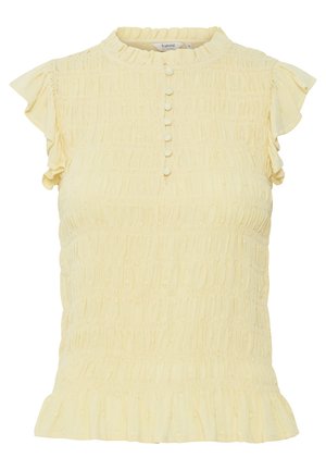 Kollane, tekstureeritud ülemine osa väikeste volangkäistega, kõrge kaelusega ja nööbiplusega. Sellel on volditud äär ja kogutud kangaste detail.