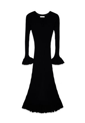 Robe noire en tricot côtelé avec une silhouette ajustée, des manches longues évasées et un ourlet à volants. Présente un petit détail en forme de trou de serrure au niveau du décolleté.