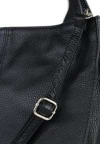 Black leather handbag with a textured surface, adjustable strap, and silver hardware accents. Features visible stitching detail.