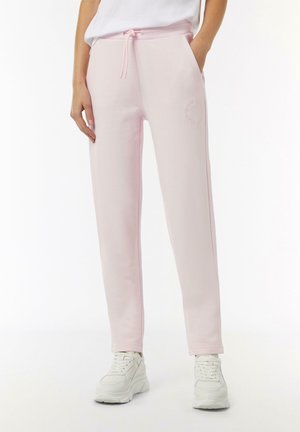 Lichtroze joggingbroek met een elastische tailleband, trekkoord, zijzakken en geborduurd logodetail. Zacht stof en taps toelopend ontwerp.