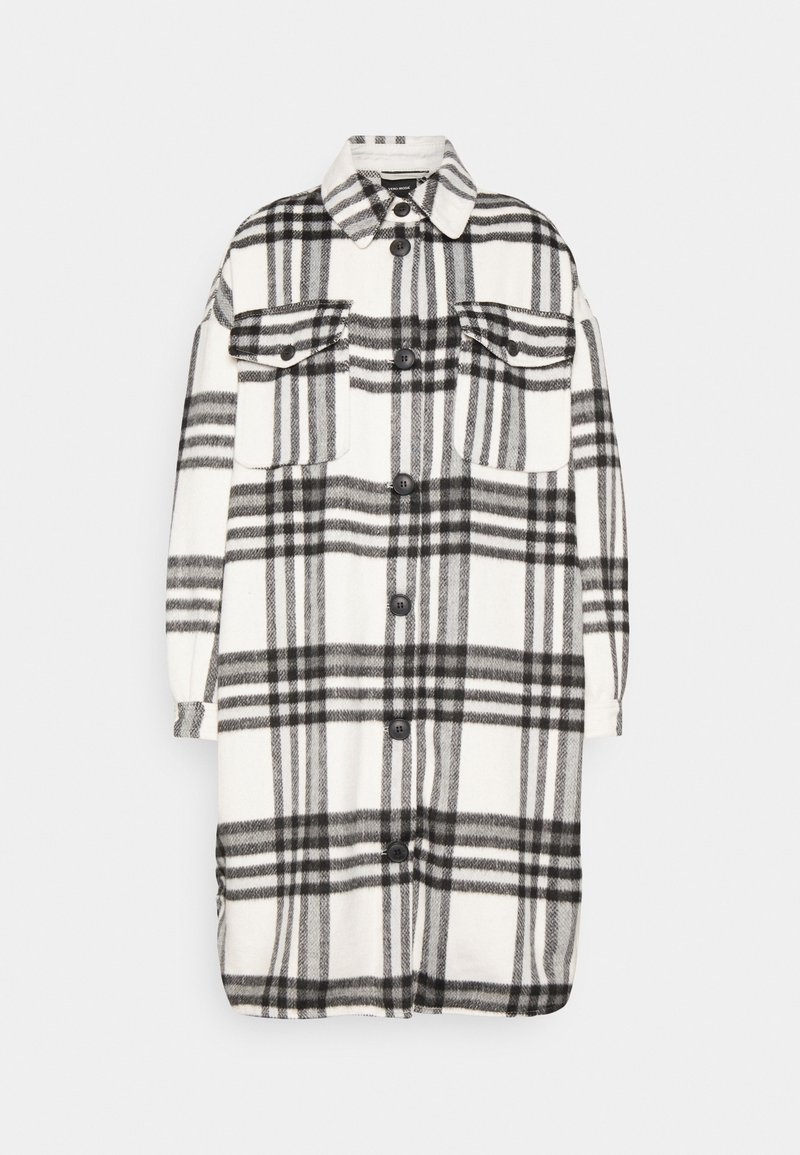 Camisa de cuadros en blanco y negro, con dos bolsillos en el pecho, un collar puntiagudo y cierre de botones. Tejido suave con un corte relajado.