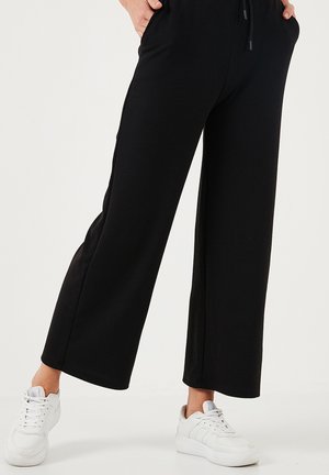 REGULAR FIT - Tracksuit bottoms - black