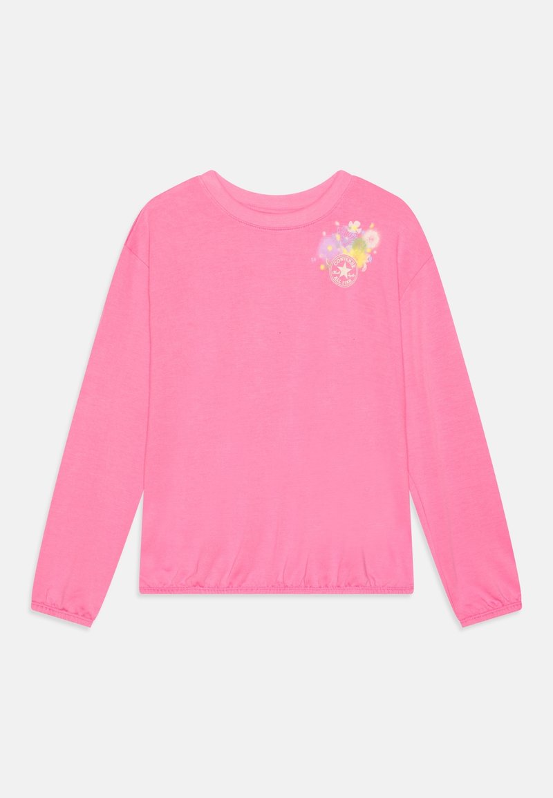 Chemise à manches longues rose vif avec poignets et ourlet élastiques, ornée d'un petit motif floral et du logo Converse sur la partie supérieure gauche de la poitrine.
