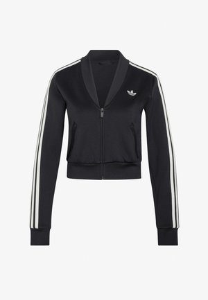 Giacca sportiva nera con zip e tre strisce bianche sulle maniche, con un piccolo logo trefoil bianco di Adidas sul petto sinistro.