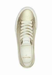Beige canvas sneaker with golden accents, white rubber sole, and flat white laces. Features a textured upper and gold logo inside.