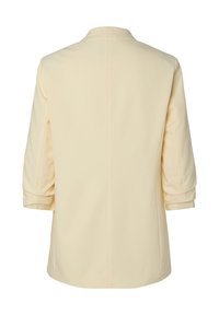 Blazer couleur crème à manches trois-quarts, vu de dos, présentant un design simple avec une seule couture centrale.