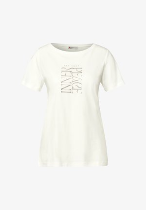 Valkoinen puuvillainen t-paita lyhyellä hihalla, jossa on hopeinen tekstimuotoilu "SAAVUTTA HERKISSI RAUHASSASI" pystysuorasti edessä.