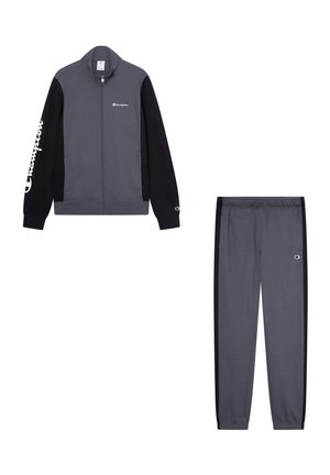 Chándal gris con chaqueta de cremallera que presenta mangas negras y un logo. Pantalones con franjas laterales negras y cinturilla elástica. Tejido suave.