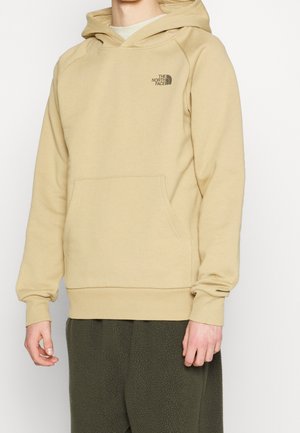 Beige Kapuzenpullover mit Kängurutasche, gerippten Bündchen und Saum sowie einem kleinen Logo auf der oberen linken Brust. Weicher Stoff.