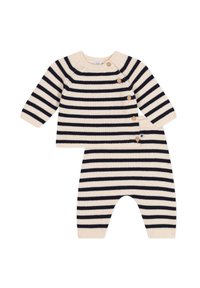 Completo a righe in maglia con base crema e righe blu. Maglia a maniche lunghe con tre bottoni in legno e pantaloni a righe abbinati.